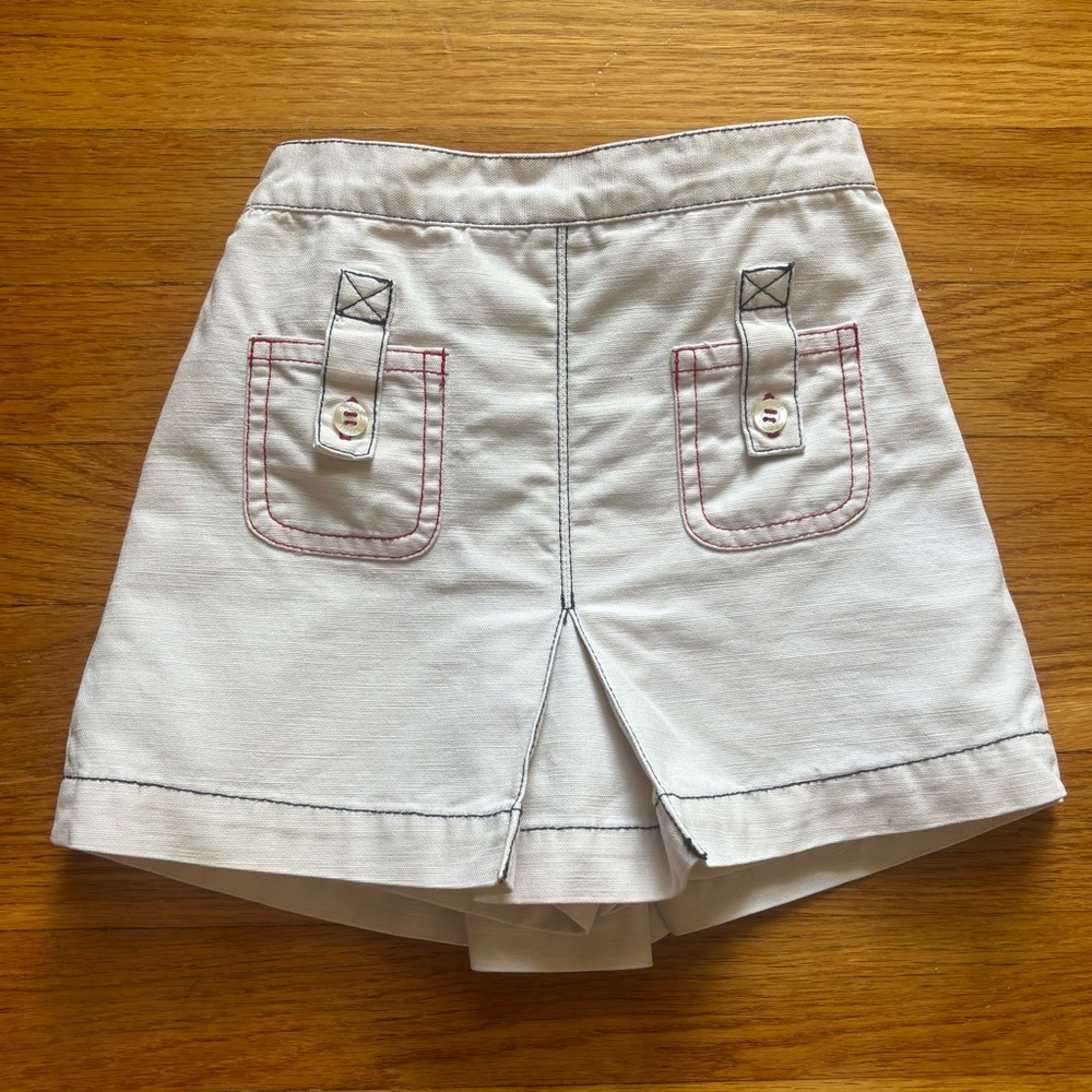 Olive Juice skort, off-white with red and navy stitching. Size 2T